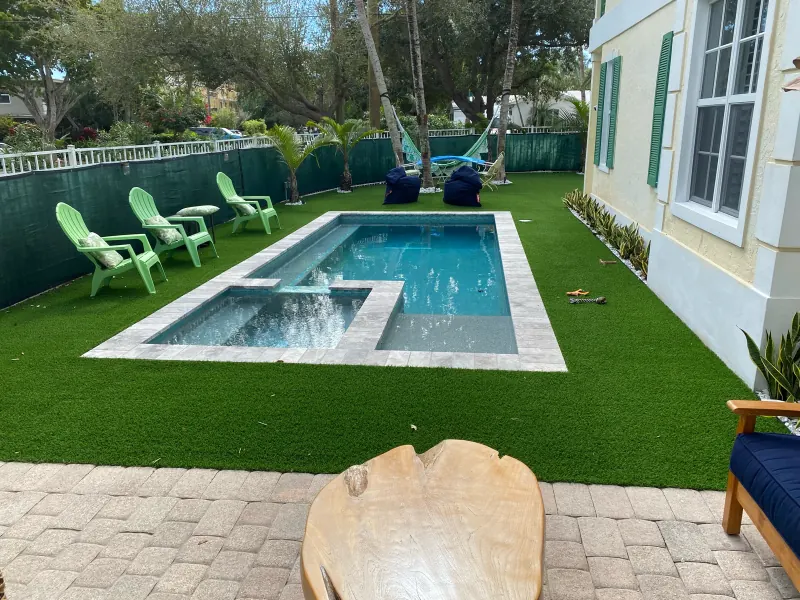 Compact pool and spa set in an artificial-turf yard