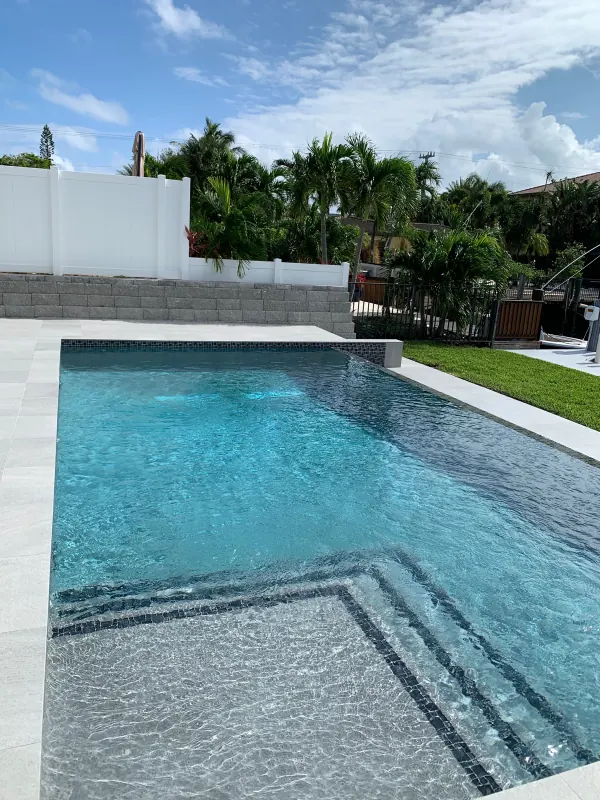 Pool with tiled steps and a raised wall