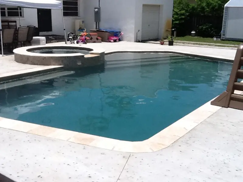 Pool with a raised spa and white deck