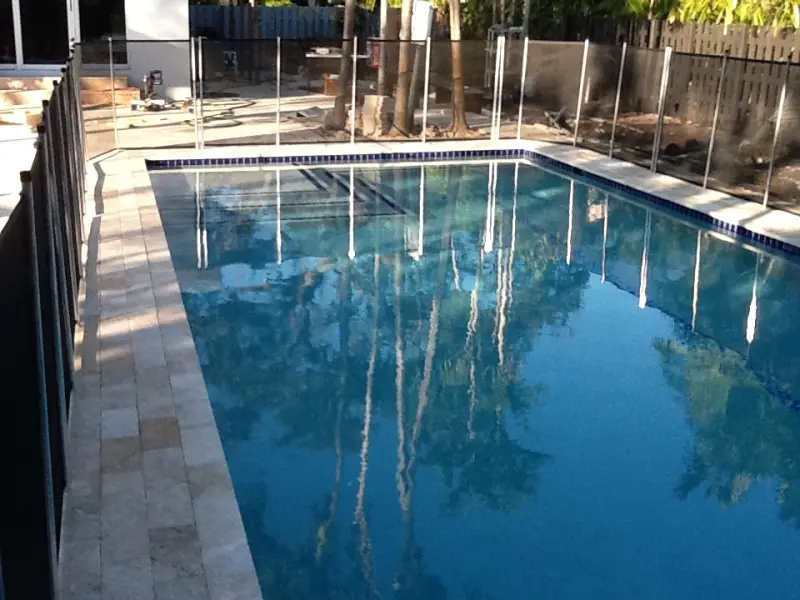 Long rectangular pool with a glass-tile waterline