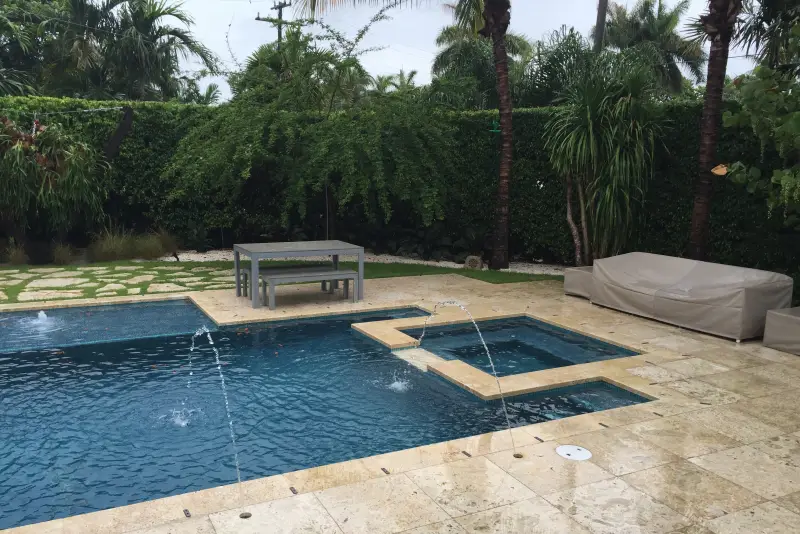 Geometric pool with attached spa and arcing deck jets