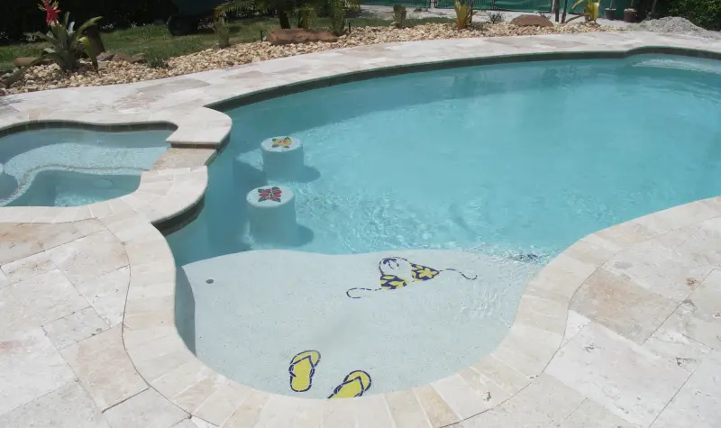 Freeform pool with tanning ledge and spa