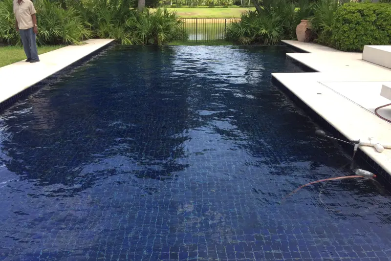 Long pool with a midnight-blue tile finish