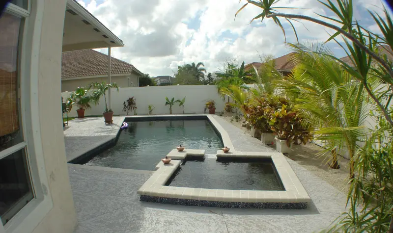 Pool and spa along a covered patio