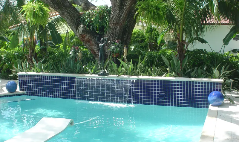 Pool with a raised glass-tile wall