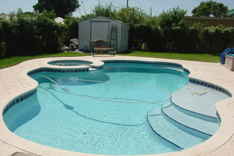 Freeform pool with wide entry steps and spa