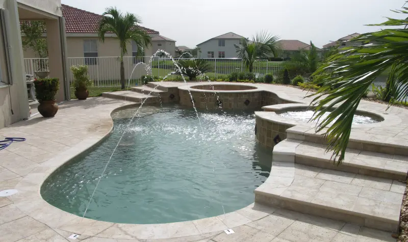 Freeform pool with spa and spillover