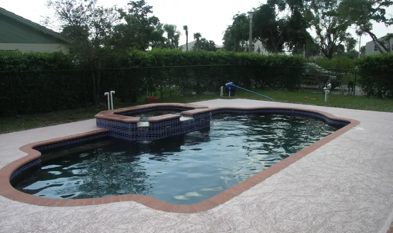 Freeform pool with spa and paver deck